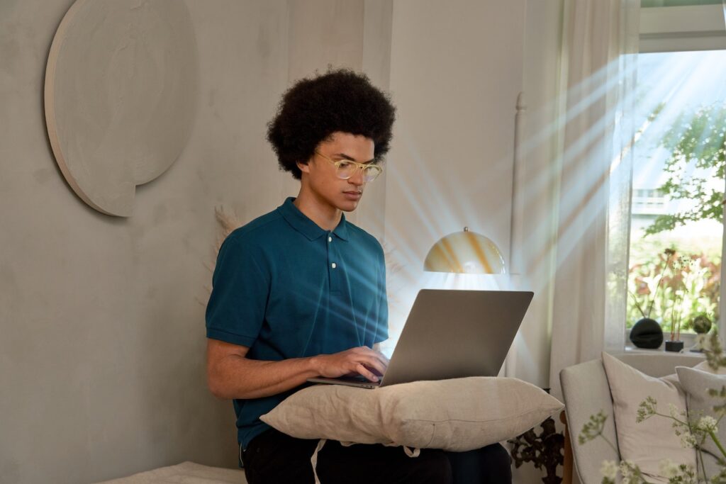 A pair of blue light blocking computer glasses placed on a laptop.